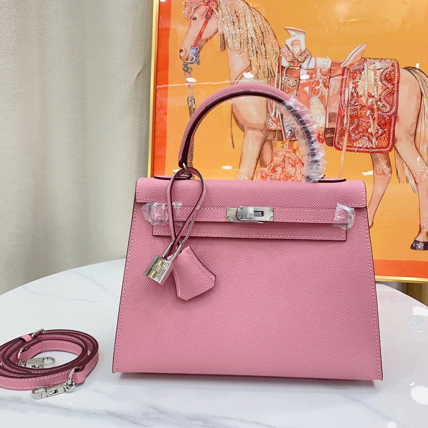 Soft Blush Bubblegum Pink Fine Tight Grain Compact Trapezoid Hand Tote With Sleek Silvery Twist Lock Hardware And Matching Pink Suspended Metal Padlock Charm