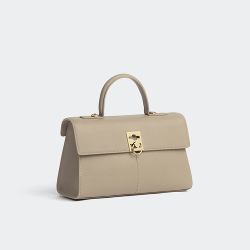 Muted Warm Taupe Fine Grain Elongated Structured Flap Hand Bag With Polished Gold Ring Clasp And Rear Zippered Storage Pocket