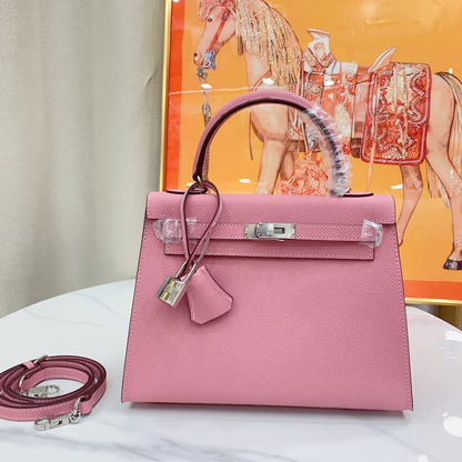 Soft Blush Bubblegum Pink Fine Tight Grain Compact Trapezoid Hand Tote With Sleek Silvery Twist Lock Hardware And Matching Pink Suspended Metal Padlock Charm